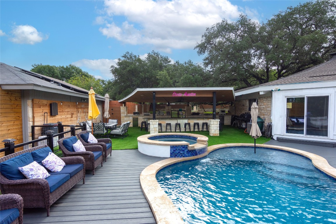 a view of a patio with couches chairs and a table and chairs with wooden floor