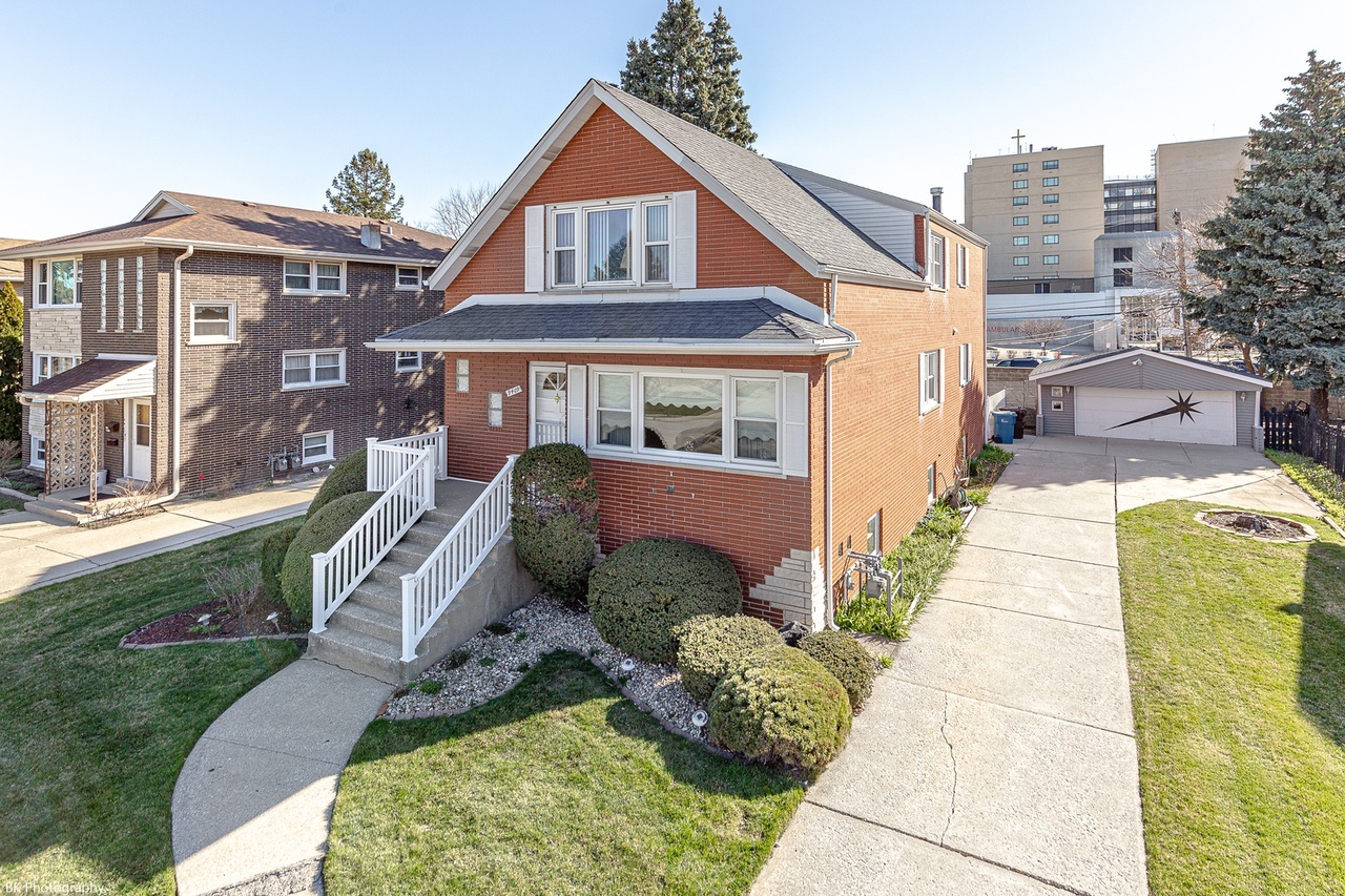 a front view of a residential apartment building with a yard