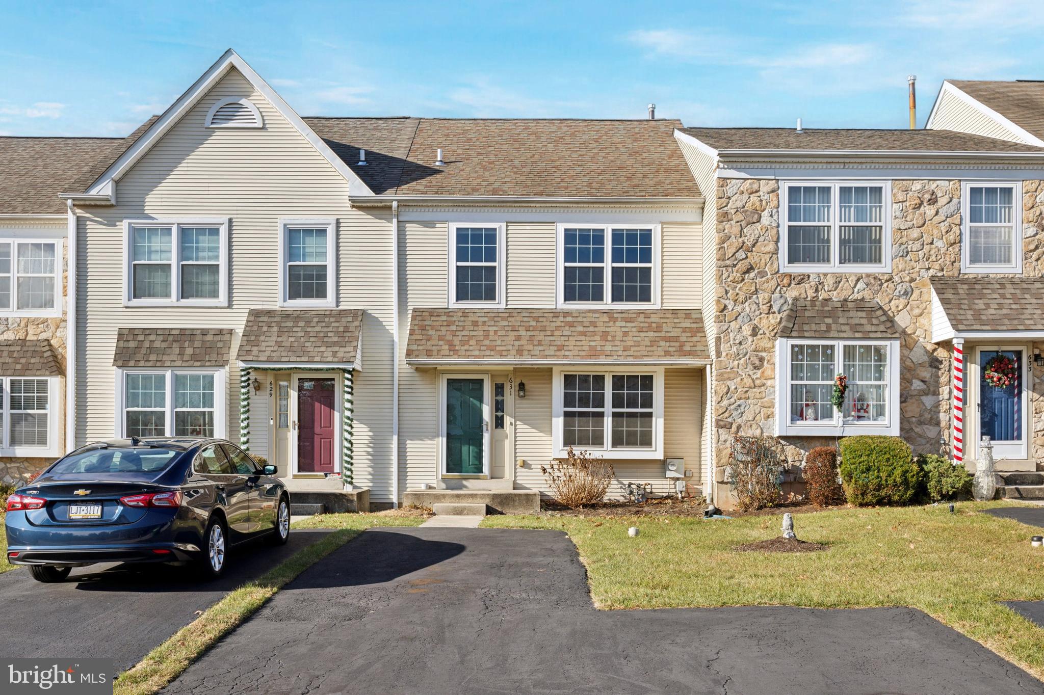 front view of a brick house with a yard