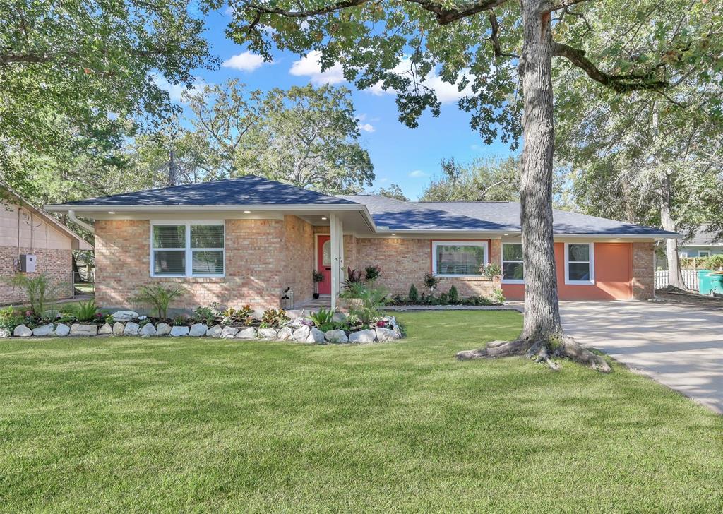 Meet this charming single-story brick home with rock lined landscaped beds, mature trees, and a cozy, welcoming entrance at 1711 N Thompson Street.