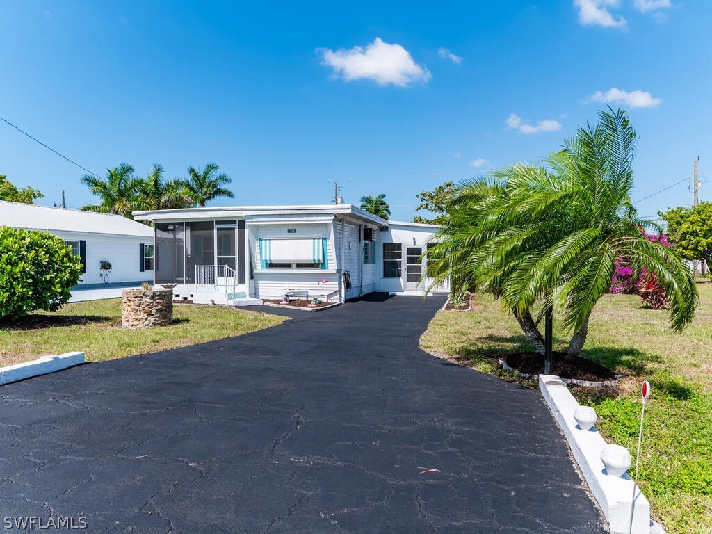 a view of a house with swimming pool and sitting area