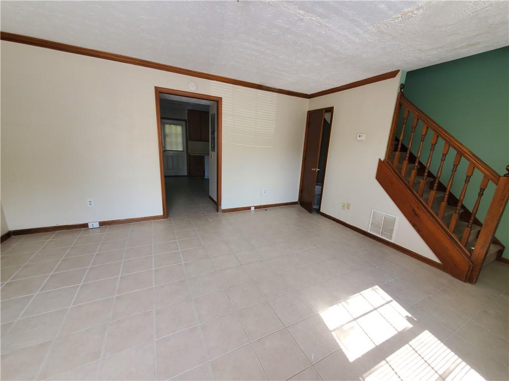 a view of an empty room with stairs