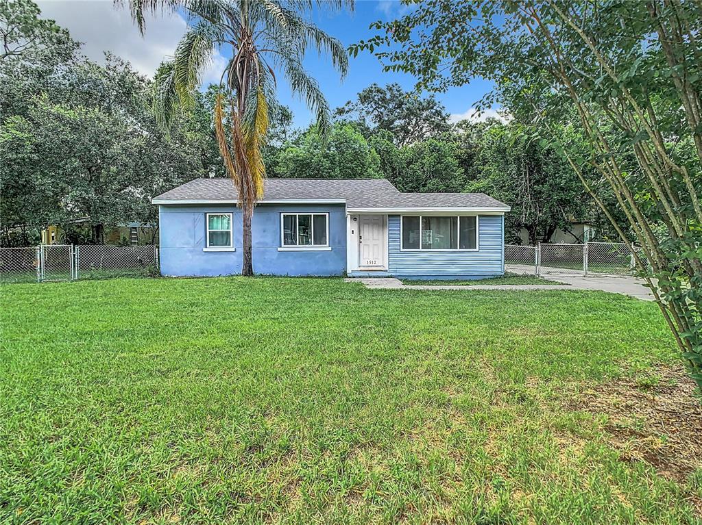 a front view of house with yard and green space