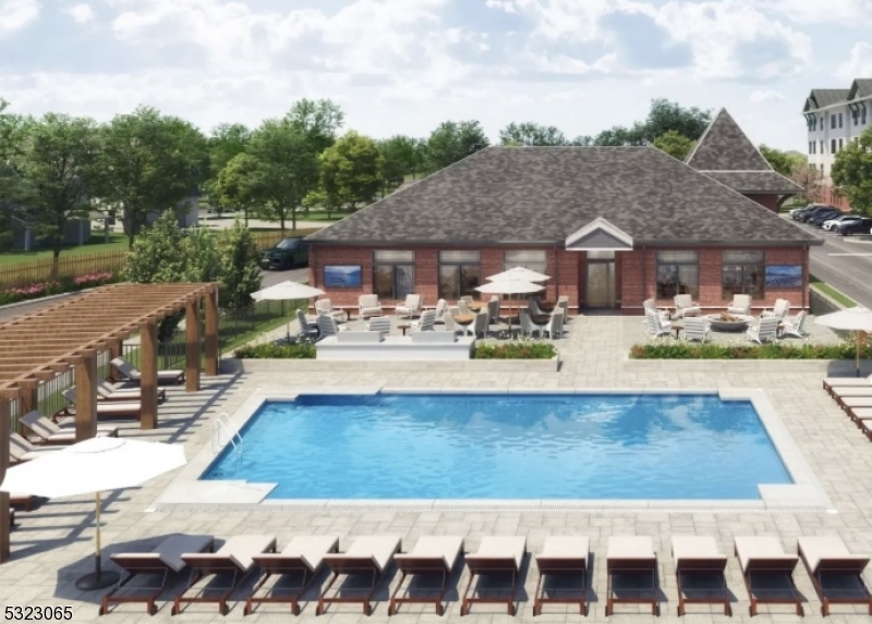 a view of a house with pool lawn chairs and a table and chairs