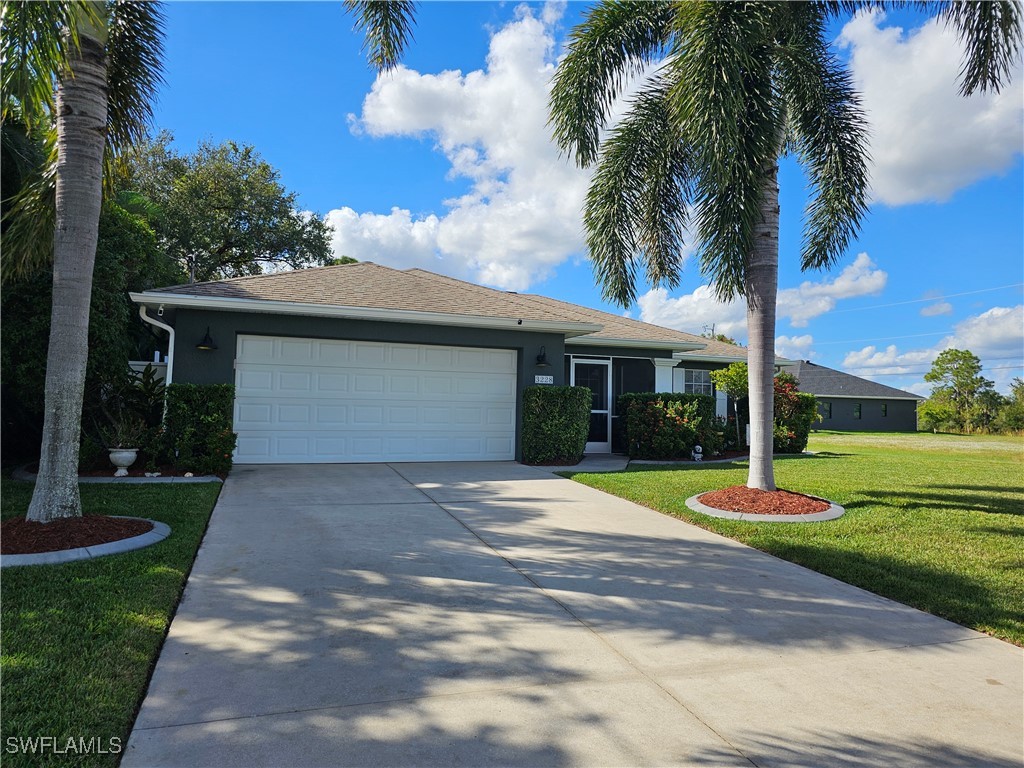 a front view of a house with a yard and garage