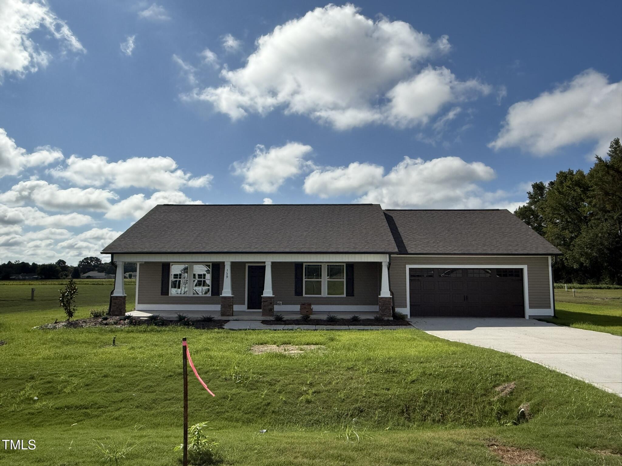 a front view of a house with a garden