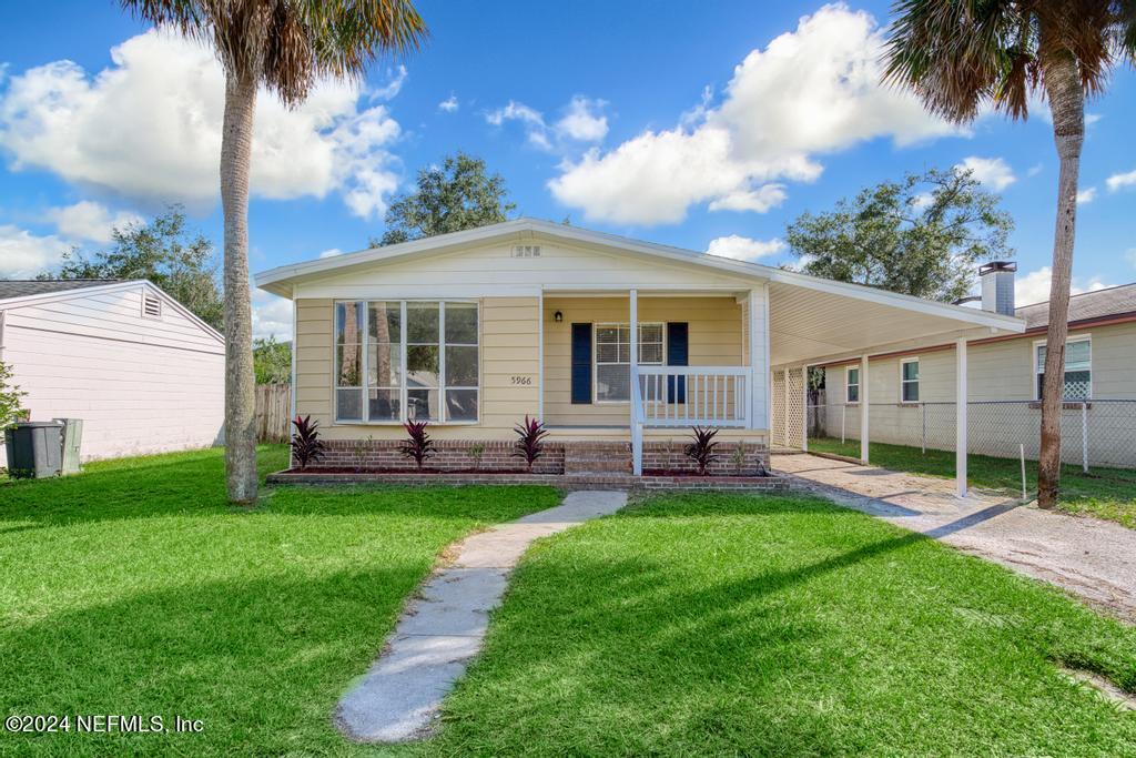 a view of a house with a backyard and a patio