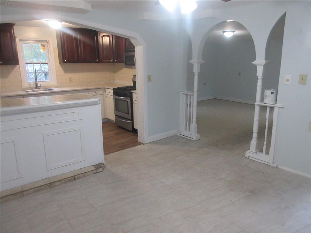 a view of a kitchen with a sink and cabinets