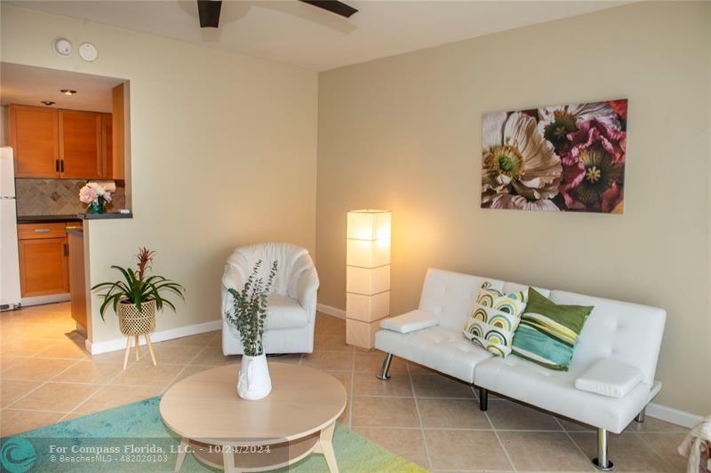 a living room with furniture and a potted plant