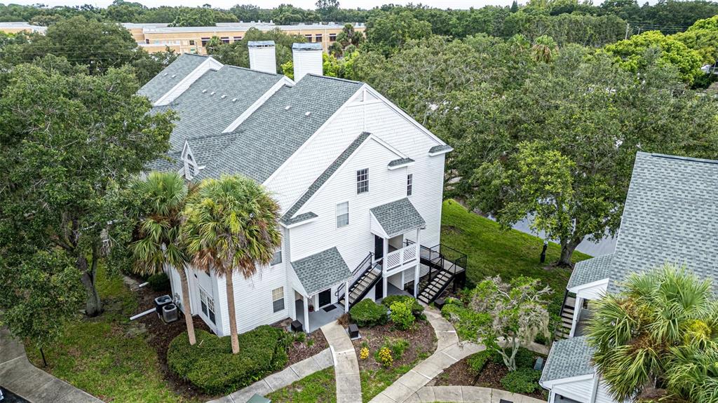 an aerial view of a house with a yard and trees