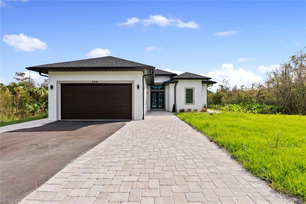 a front view of a house with yard and green space