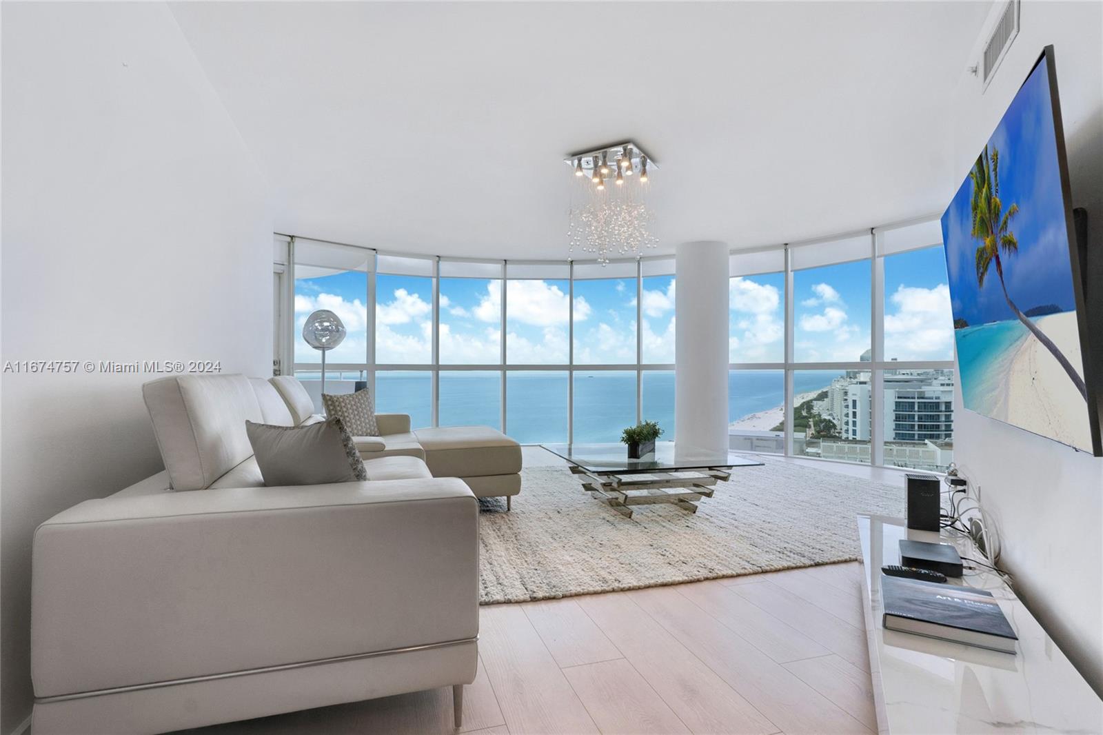 a living room with furniture and a floor to ceiling window