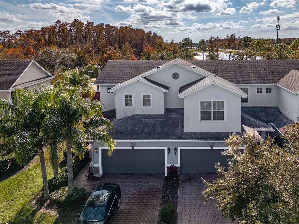 an aerial view of a house with a yard