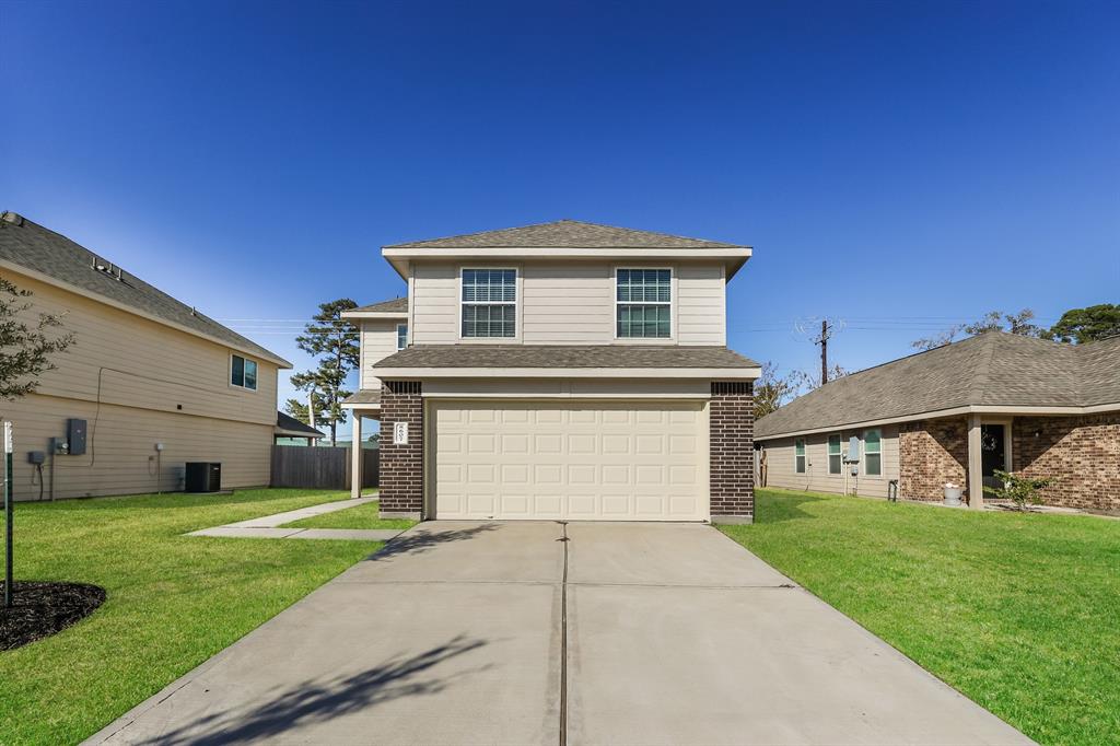 a front view of a house with a yard and garage