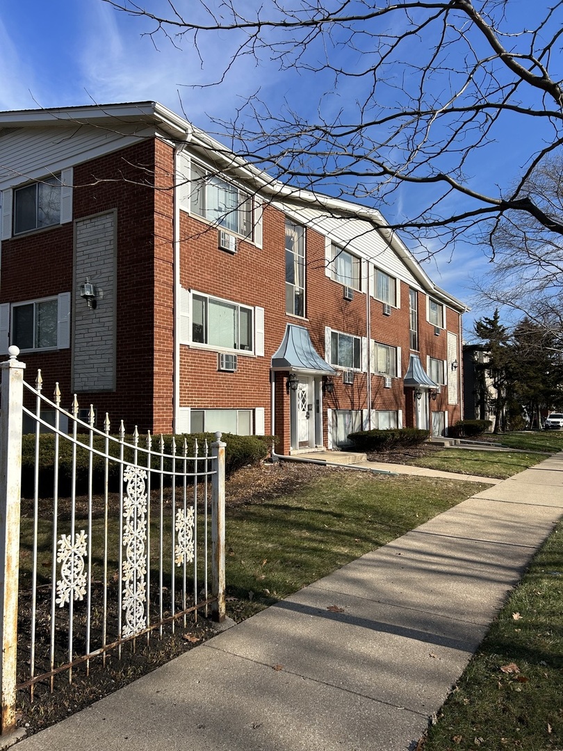 a view of a brick building next to a yard