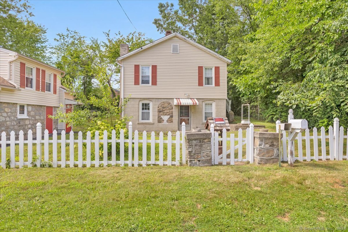 a view of a house with wooden fence