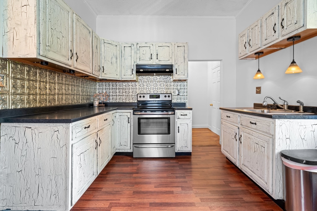 a kitchen with stainless steel appliances granite countertop a stove a sink and a refrigerator