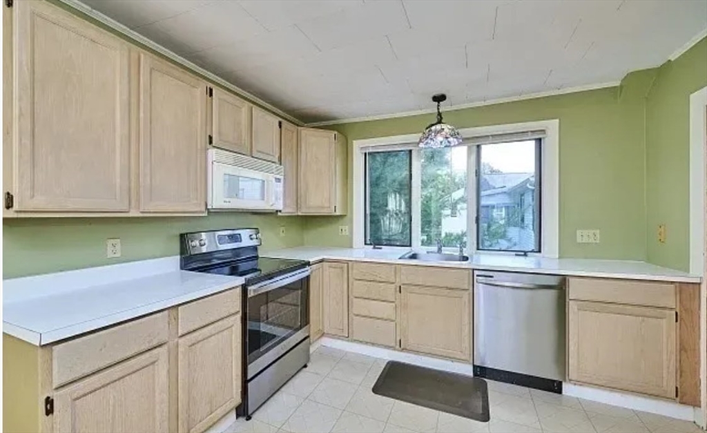 a kitchen with granite countertop white cabinets and white appliances