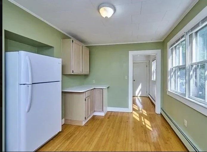 a kitchen with a refrigerator and a sink