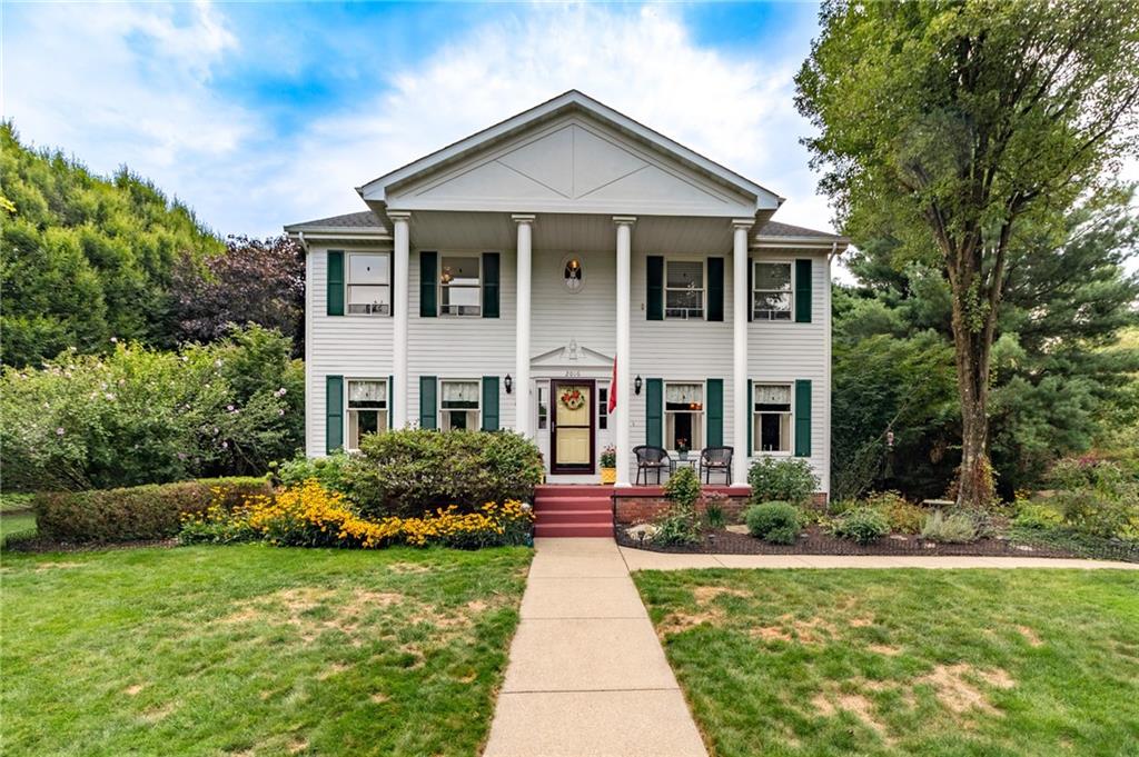 a front view of house with yard and green space