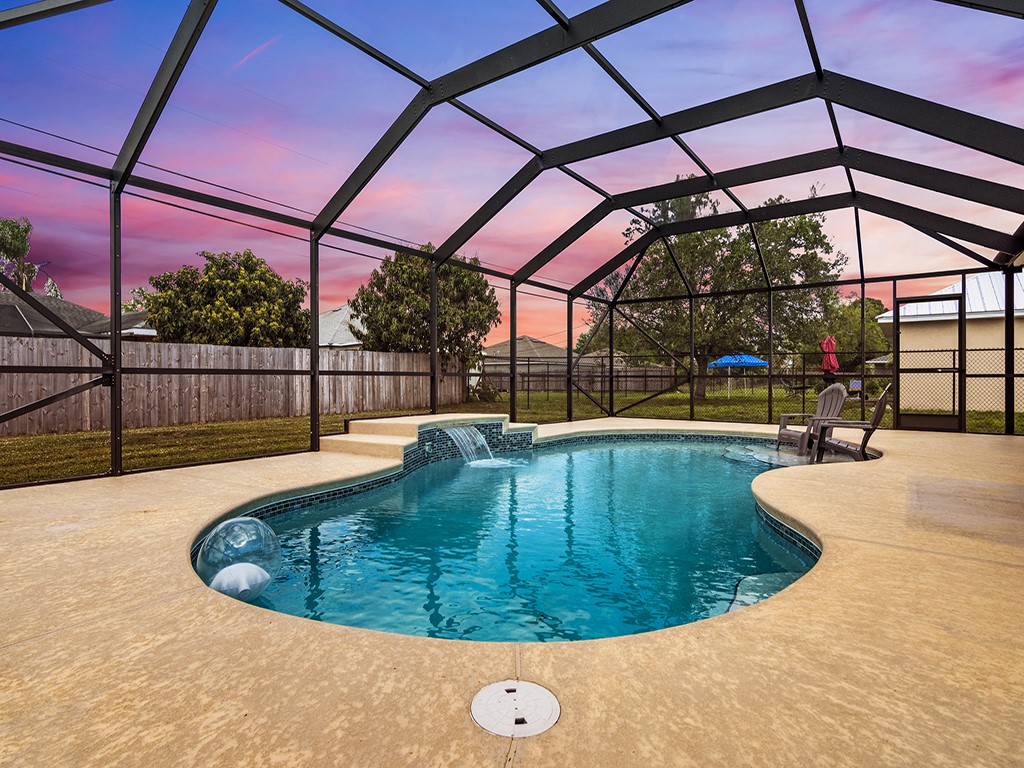 a view of outdoor space with swimming pool and sitting space