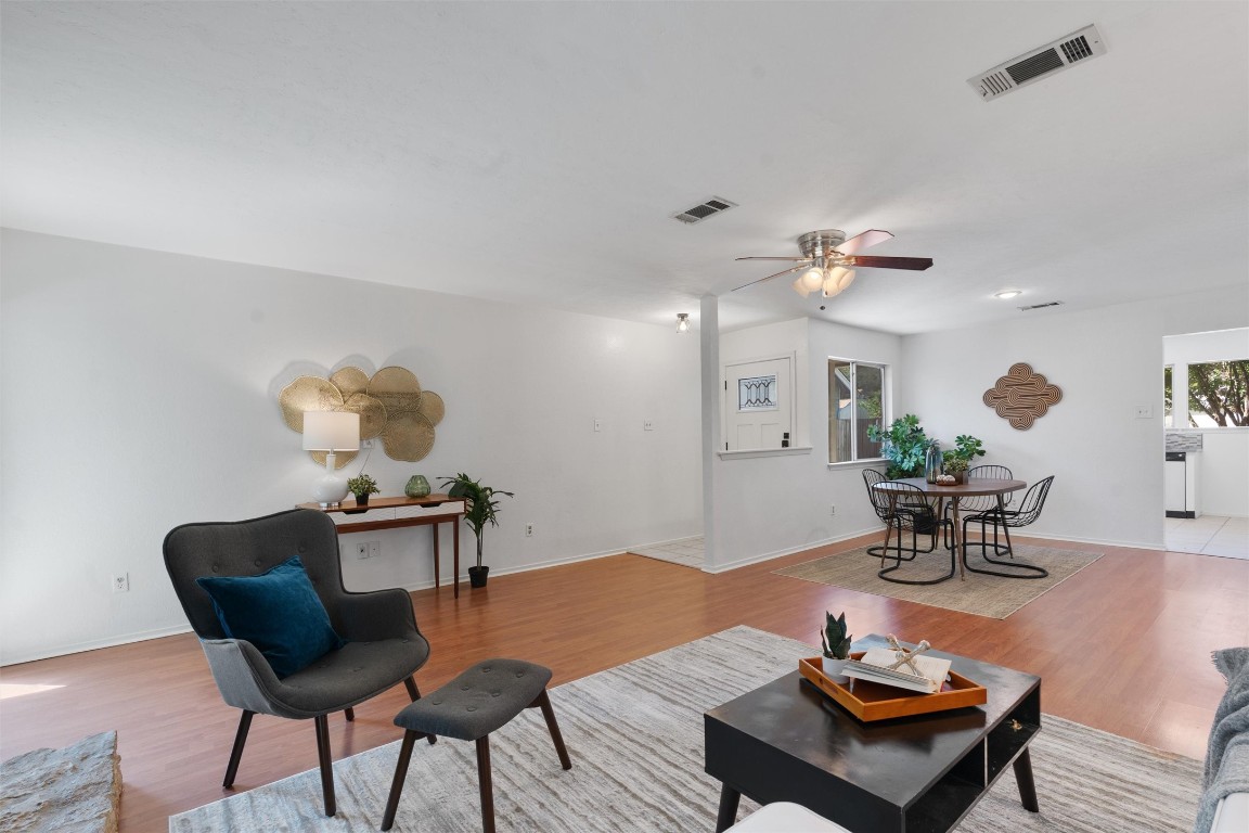 a living room with furniture and wooden floor