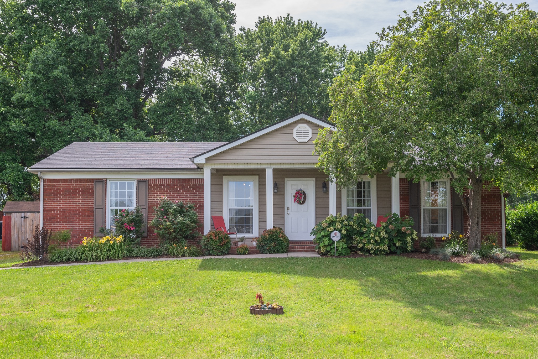 a front view of a house with garden