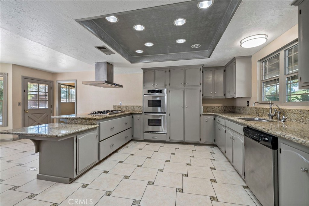 a large kitchen with stainless steel appliances and cabinets