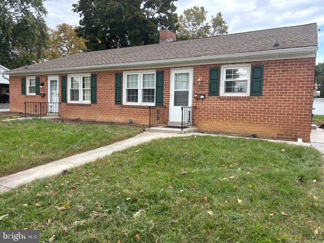 a front view of a house with a yard and porch