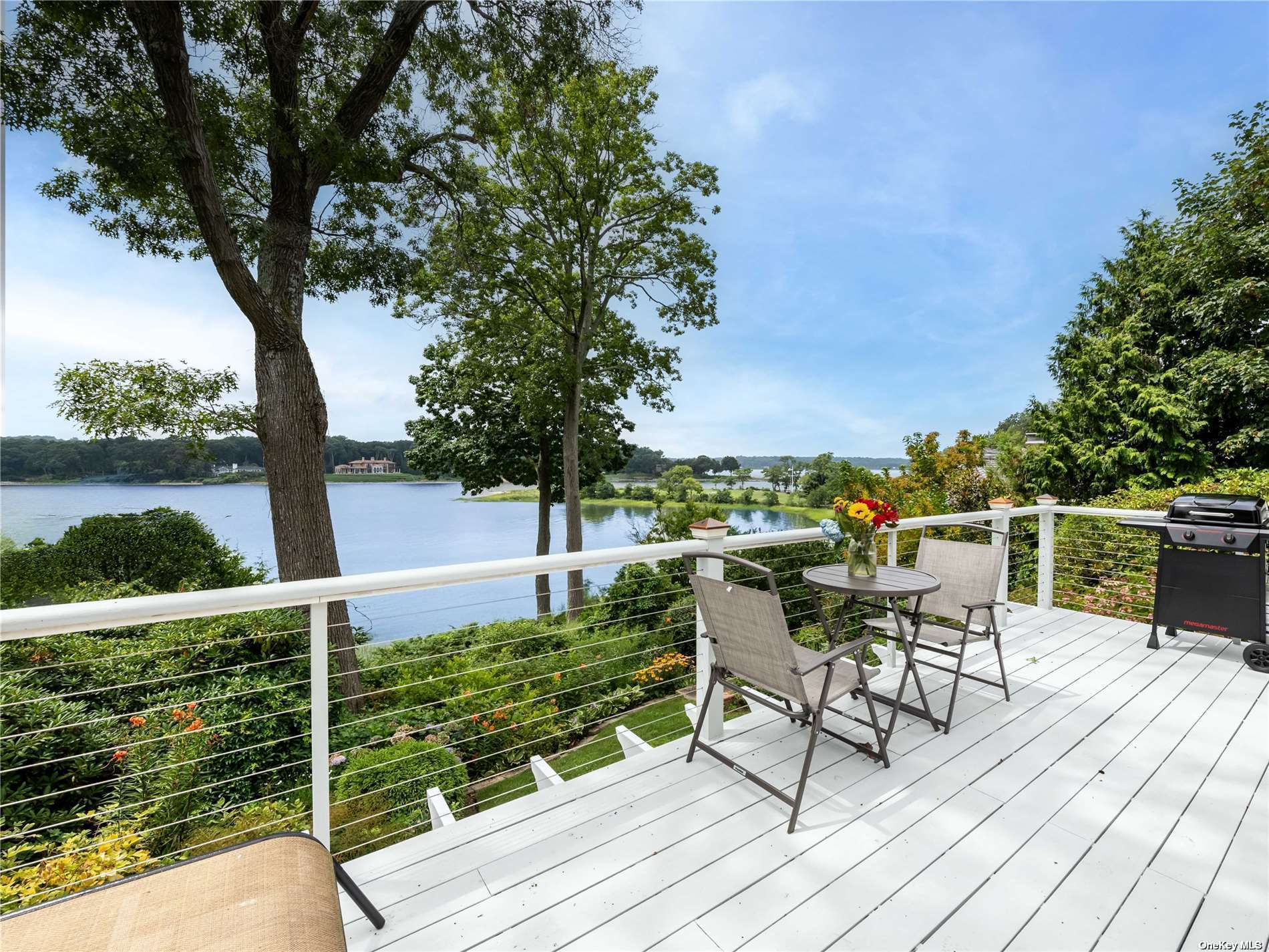 a balcony with wooden floor table and chairs