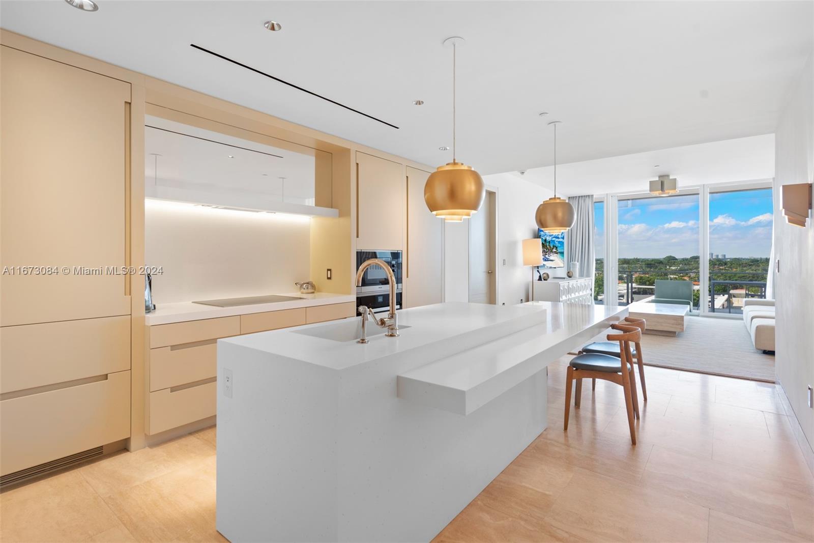 a large kitchen with a large window and stainless steel appliances