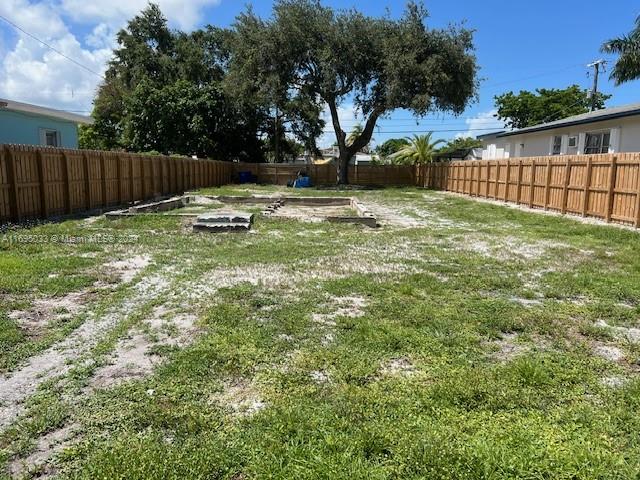 a view of a backyard with a tree