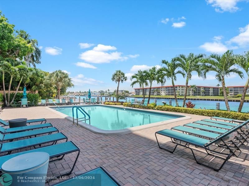 a swimming pool with outdoor seating and yard