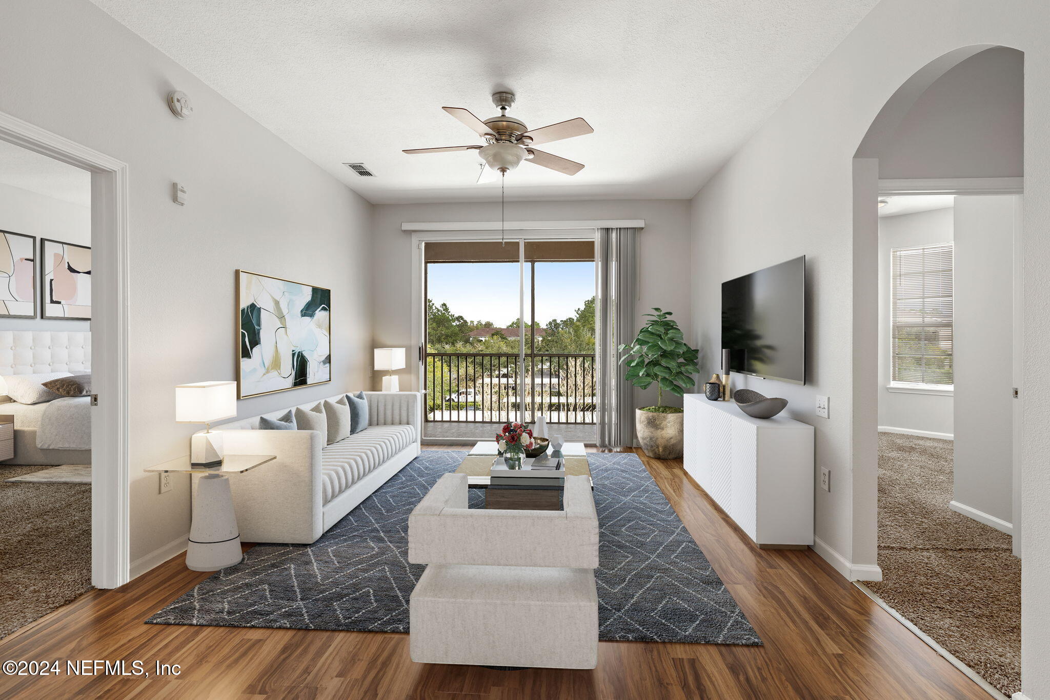 a living room with furniture and a flat screen tv