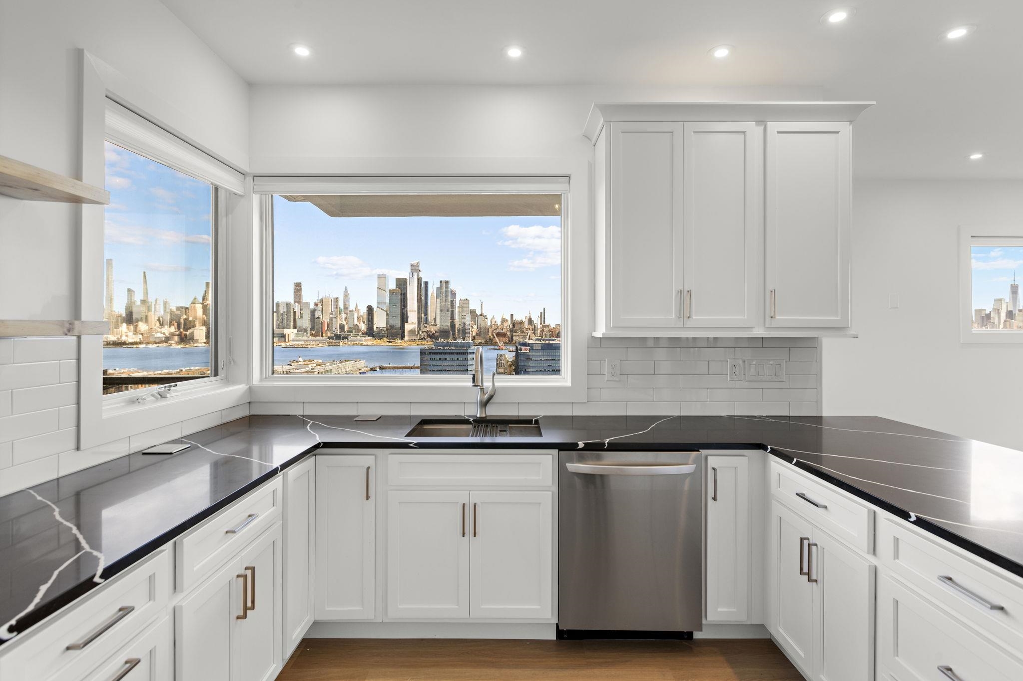 a kitchen with granite countertop white cabinets and white appliances