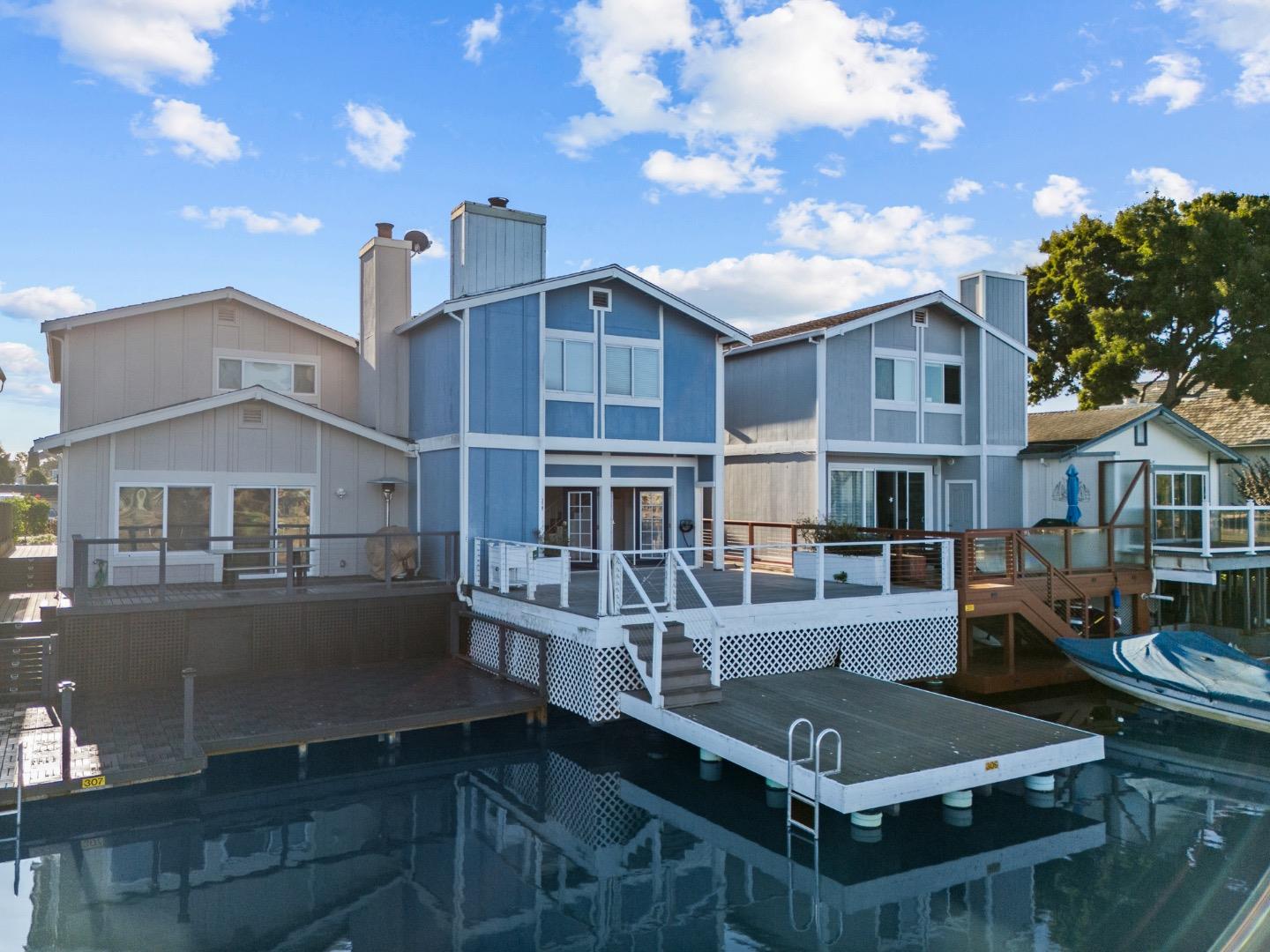 a view of house with yard and outdoor seating