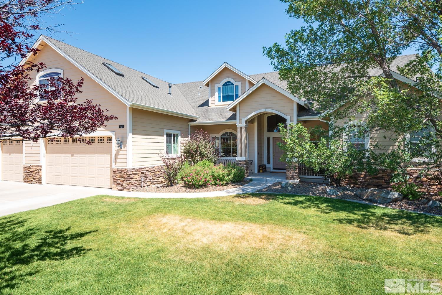 a front view of a house with a yard and garage