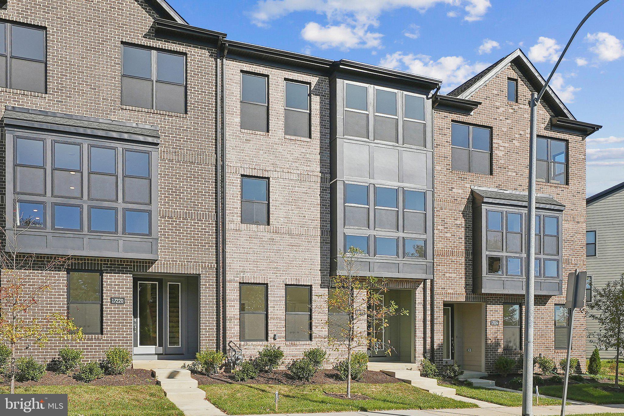 a front view of a residential apartment building with a yard