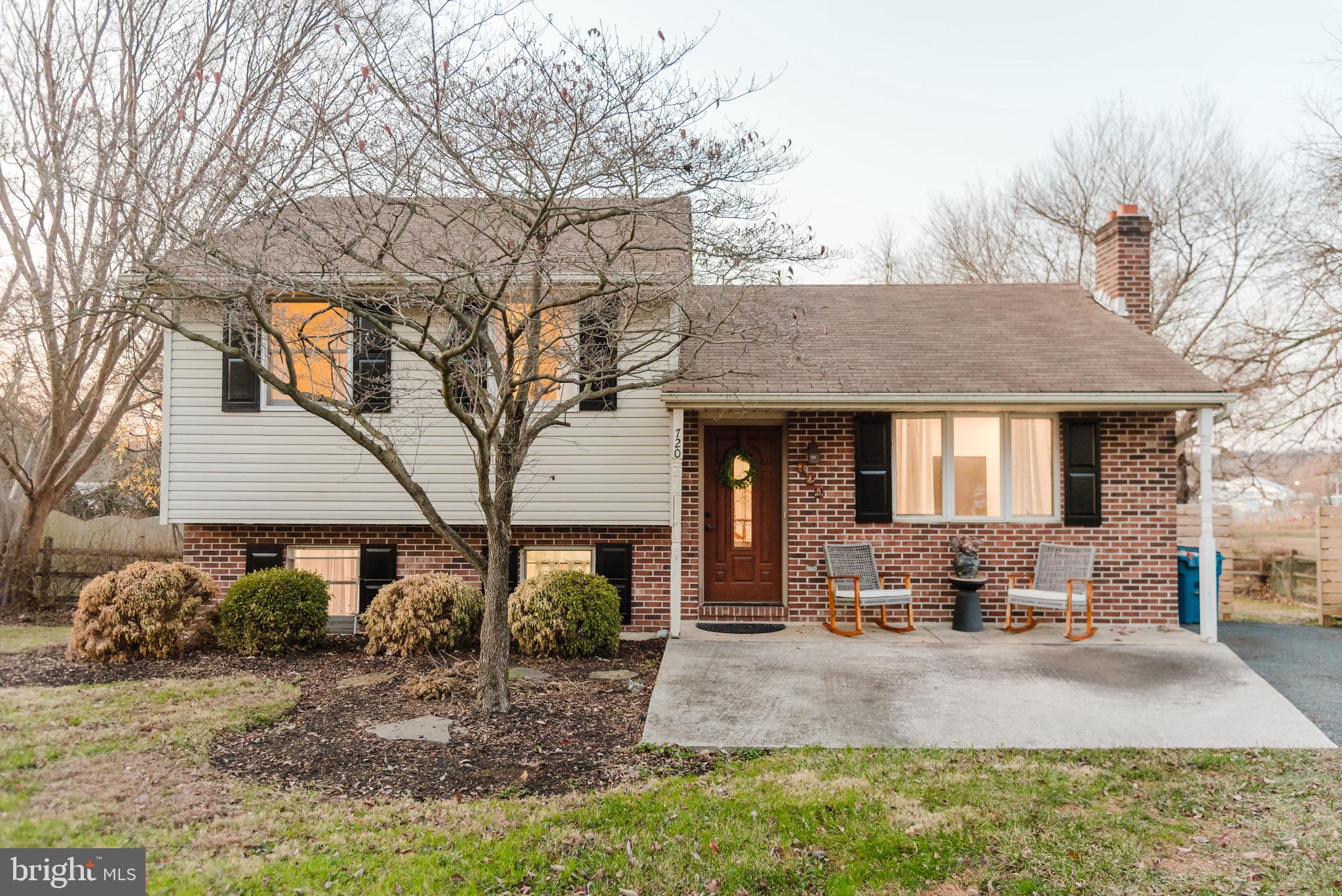 a front view of a house with garden and patio