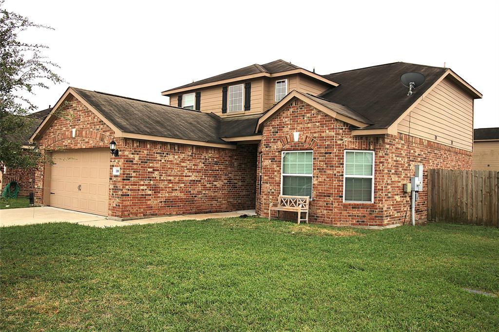 a front view of a house with a garden and yard