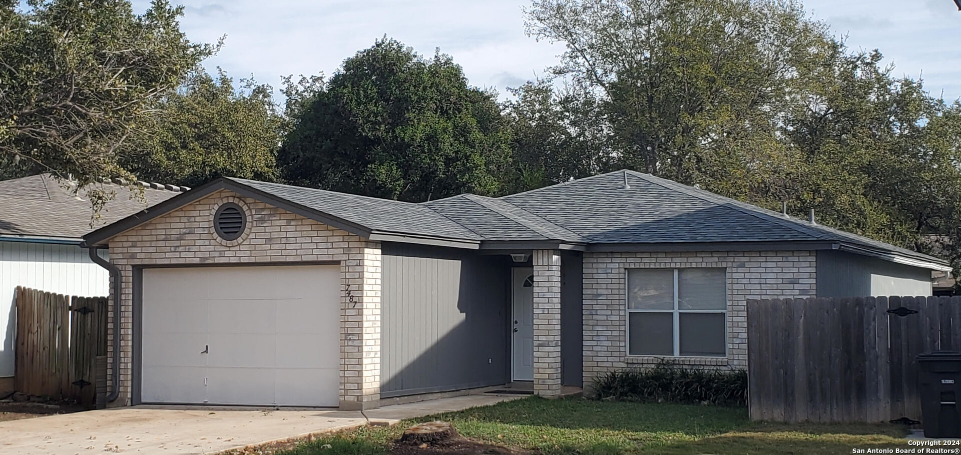 a front view of a house with a garden and yard