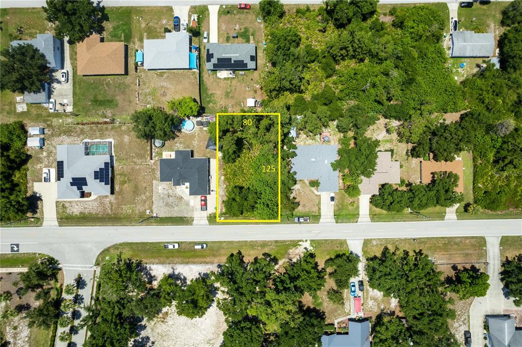 an aerial view of a house with a yard swimming pool and outdoor seating