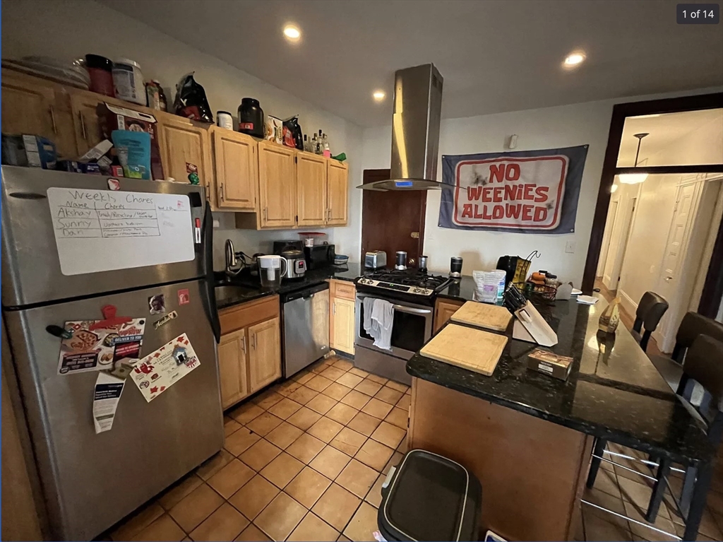 a kitchen with stainless steel appliances granite countertop a refrigerator and a sink