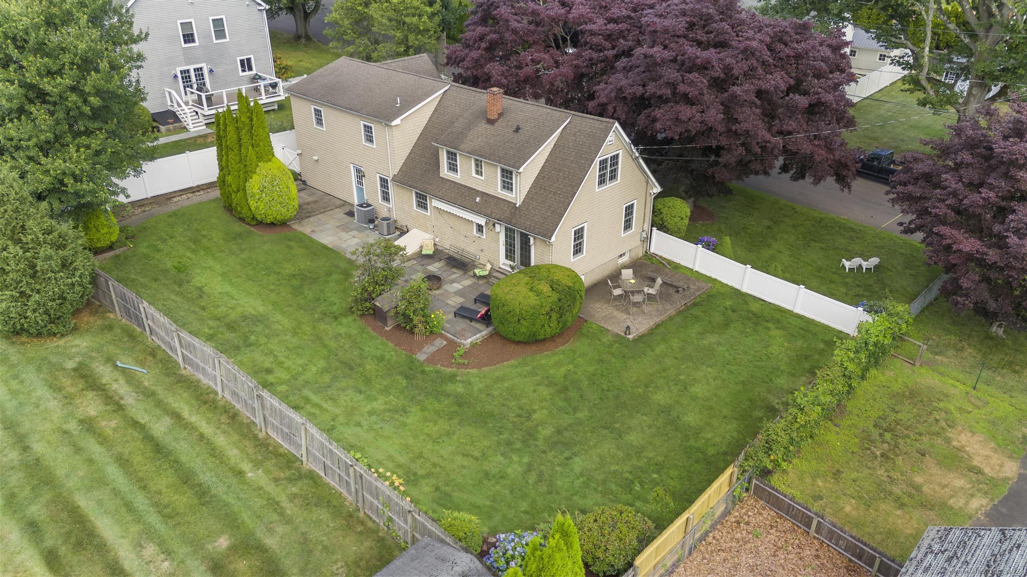 an aerial view of a house with garden space and street view