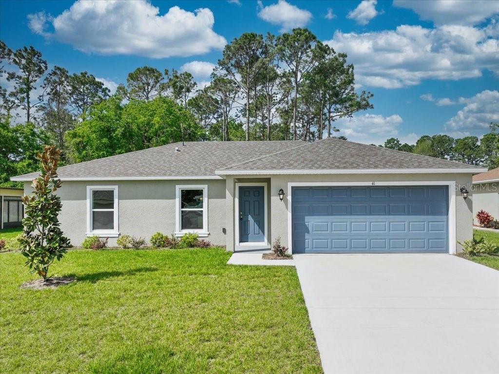 a front view of house with yard and green space