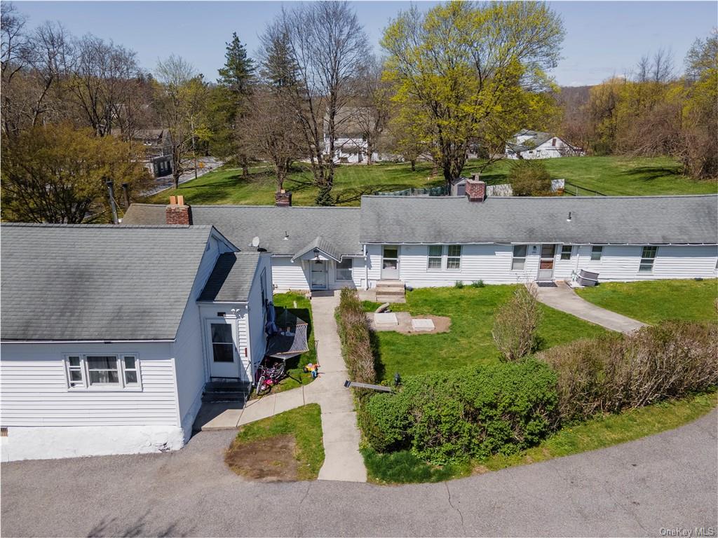 an aerial view of a house with garden space and street view