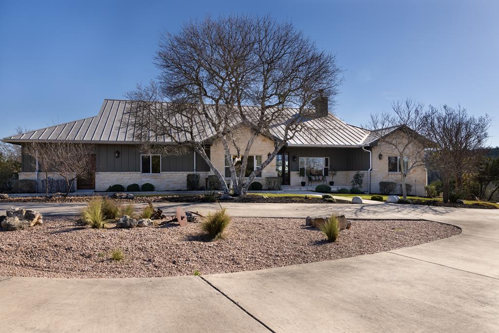 a view of a house with swimming pool and sitting area