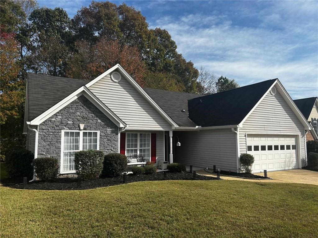 a view of a house with a yard and sitting area