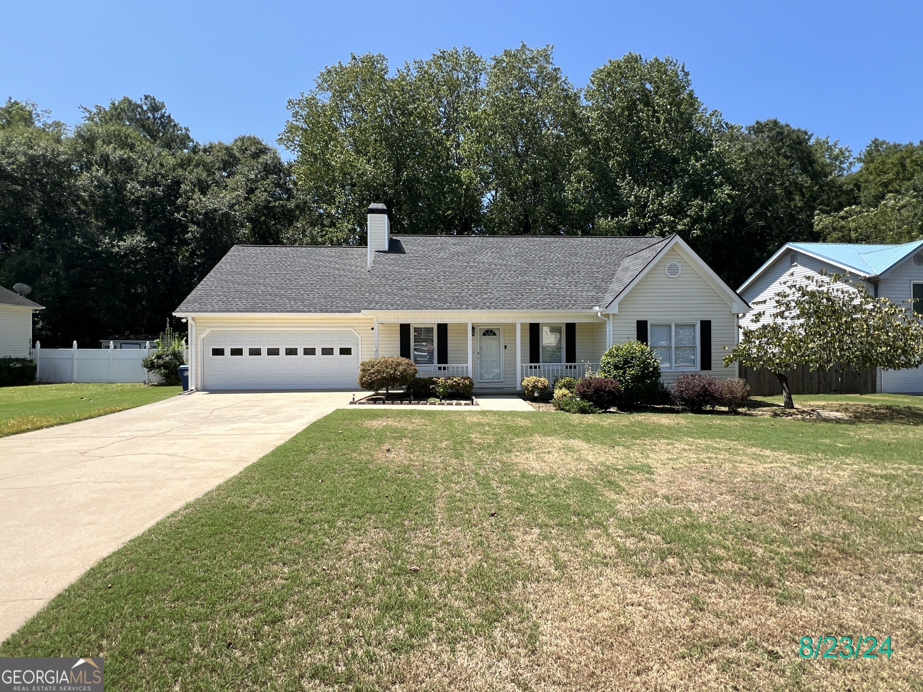 a front view of a house with a yard and trees