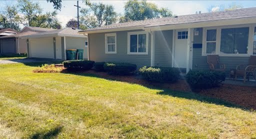 a view of an house with backyard space and garden